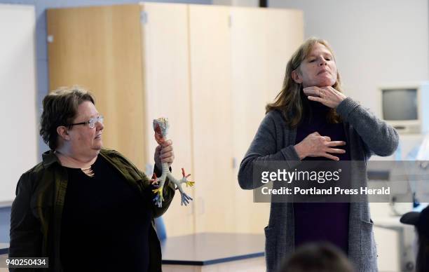 Linguistics professor Judy Shepard-Kegl holds a model of trachea and bronchi as she watches medical interpreter and student Polly Lawson interpreting...