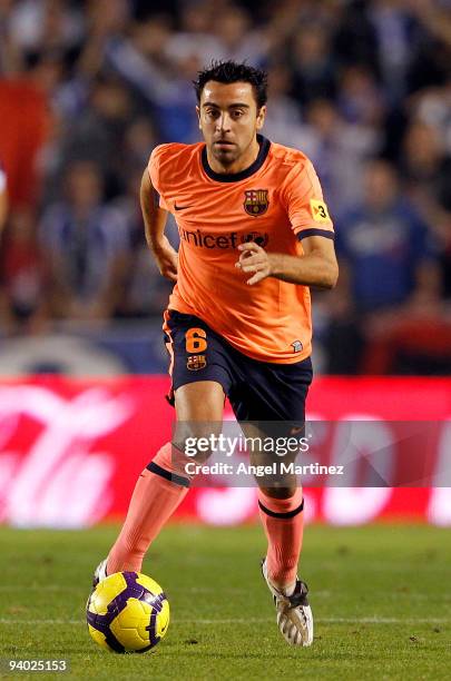 Xavi Hernandez of Barcelona runs with the ball during the La Liga match between Deportivo La Coruna and Barcelona at the Riazor stadium on December...