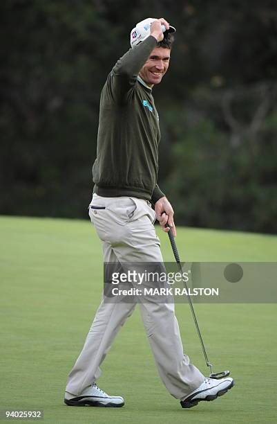 World number five Padraig Harrington of Ireland smiles after sinking his putt on the 18th hole at the Sherwood Country Club on day three of the...