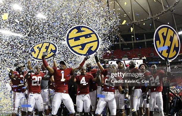 The Alabama Crimson Tide celebrate as confetti falls after their 32-13 win against the Florida Gators during the SEC Championship game at Georgia...