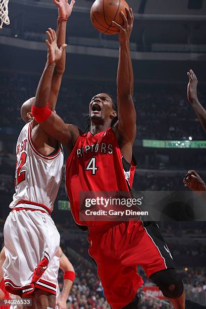 Chris Bosh of the Toronto Raptors shoots a layup against Taj Gibson of the Chicago Bulls on December 5, 2009 at the United Center in Chicago,...