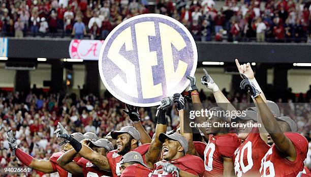 Members of the Alabama Crimson Tide celebrate after defeating the Florida Gators 31-13 during the SEC Championship at the Georgia Dome on December 5,...