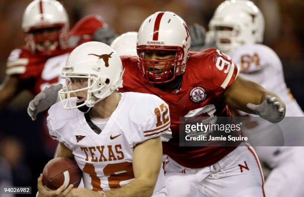 Quarterback Colt McCoy of the Texas Longhorns is sacked by Ndamukong Suh of the Nebraska Cornhuskers in the first quarter of the game at Cowboys...