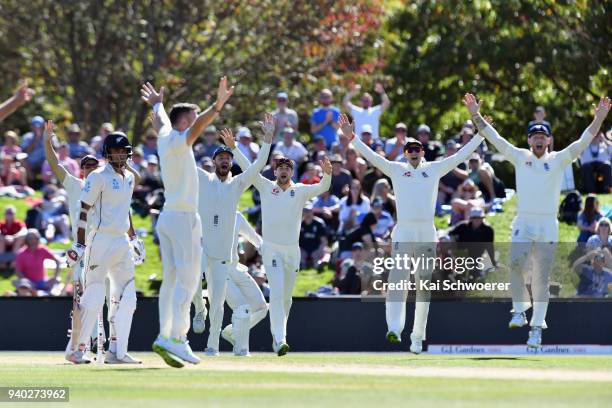 James Vince, Dawid Malan, Joe Root and Ben Stokes of England celebrate after James Anderson of England dismisses Jeet Raval of New Zealand during day...