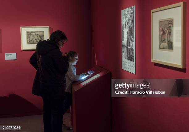 Visitors at the Museu de Arte Popular take in the work of Dutch artist Maurits Cornelis Escher on March 30, 2018 in Lisbon, Portugal. This exhibition...
