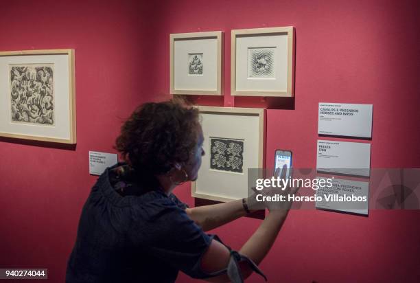 Visitor at the Museu de Arte Popular takes in the work of Dutch artist Maurits Cornelis Escher on March 30, 2018 in Lisbon, Portugal. This exhibition...