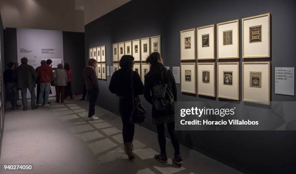 Visitors at the Museu de Arte Popular take in the work of Dutch artist Maurits Cornelis Escher on March 30, 2018 in Lisbon, Portugal. This exhibition...