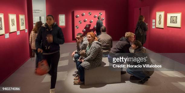Visitors at the Museu de Arte Popular take in the work of Dutch artist Maurits Cornelis Escher on March 30, 2018 in Lisbon, Portugal. This exhibition...