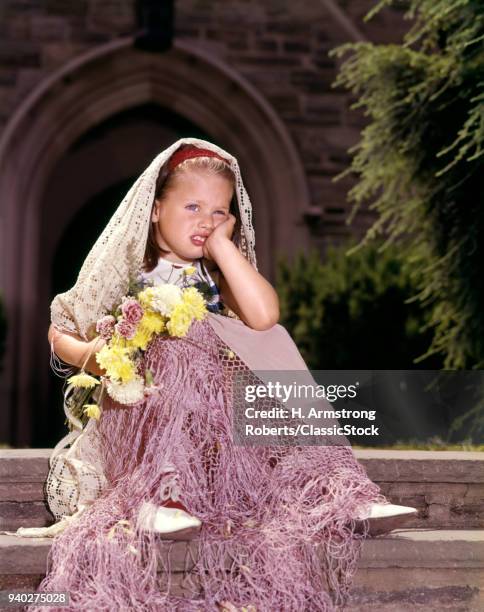 1960s UNHAPPY LITTLE GIRL SITTING IN FRONT OF CHURCH JILTED LEFT WAITING AT THE ALTAR