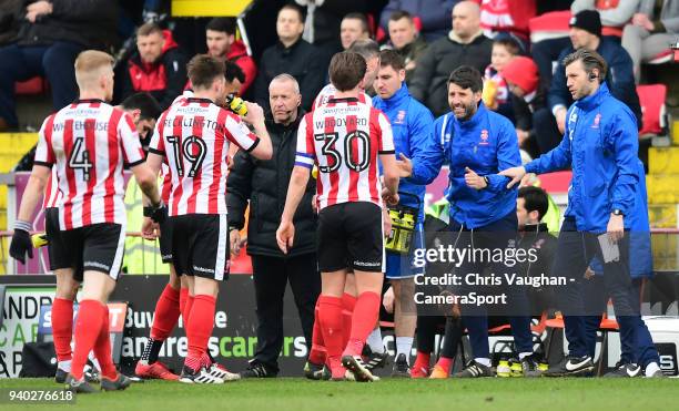 Lincoln City manager Danny Cowley, second in from right, and Lincoln City's assistant manager Nicky Cowley, right, speak to their players during the...