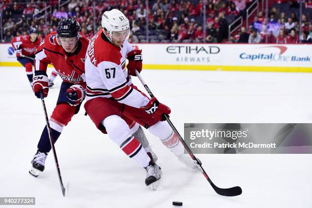 Trevor van Riemsdyk of the Carolina Hurricanes and Jakub Vrana of the Washington Capitals battle for the puck in the first period at Capital One...