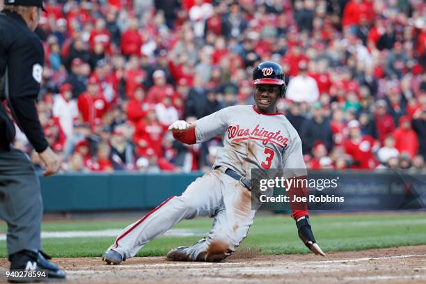 Michael A. Taylor of the Washington Nationals slides safely at home plate to score after a sacrifice fly by Brian Goodwin in the ninth inning of the...