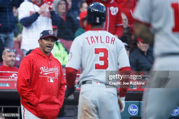 Washington Nationals manager Dave Martinez congratulates Michael A. Taylor after he scored a run on a sacrifice fly by Brian Goodwin in the ninth...