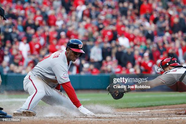 Michael A. Taylor of the Washington Nationals slides safely at home plate to score after a sacrifice fly by Brian Goodwin in the ninth inning of the...