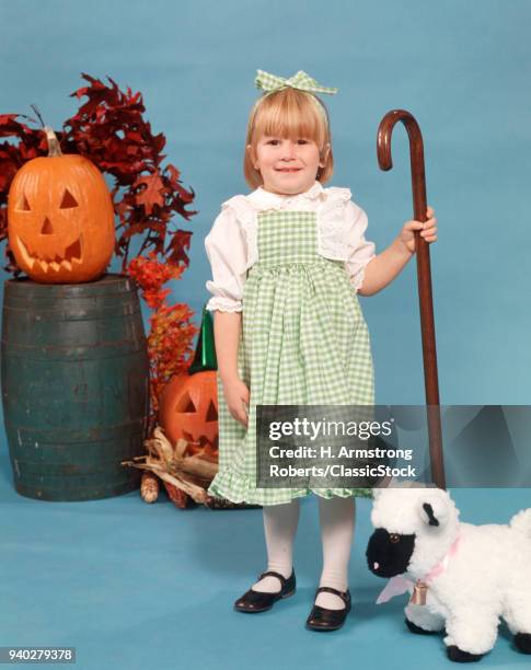 1970s CHILD GIRL LOOKING AT CAMERA WEARING SHEPHERD HALLOWEEN COSTUME LAMB PUMPKIN JACK-O-LANTERN