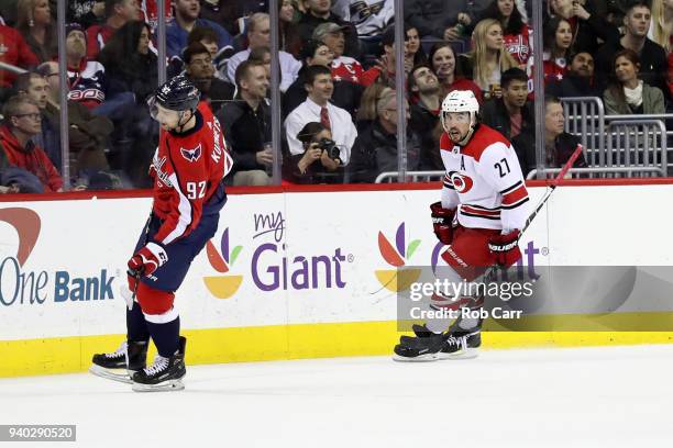 Justin Faulk of the Carolina Hurricanes skates on the ice in front of Evgeny Kuznetsov of the Washington Capitals after scoring a second period goal...