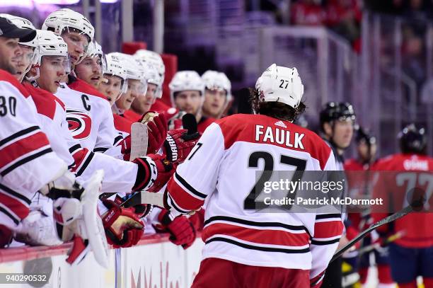 Justin Faulk of the Carolina Hurricanes celebrates with his teammates after scoring a second period goal against the Washington Capitals at Capital...