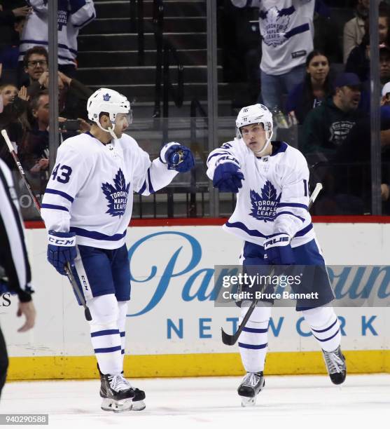 Mitchell Marner of the Toronto Maple Leafs celebrates his goal at 17:18 of the second period against the New York Islanders along with Nazem Kadri at...