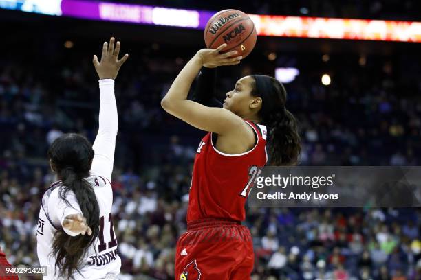 Asia Durr of the Louisville Cardinals attempts a shot defended by Roshunda Johnson of the Mississippi State Lady Bulldogs during the second half in...