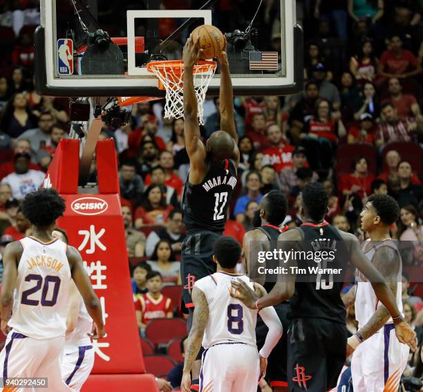 Luc Mbah a Moute of the Houston Rockets dunks the ball in the first half against the Phoenix Suns at Toyota Center on March 30, 2018 in Houston,...