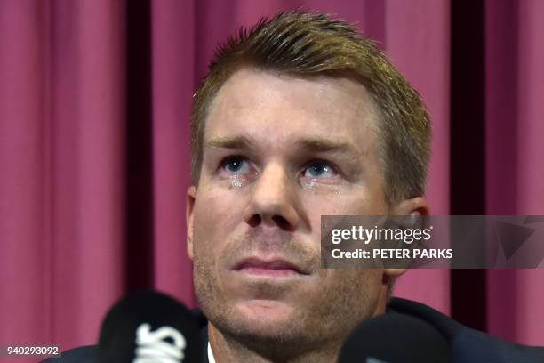 Australian cricketer David Warner listens to a question at a press conference at the Sydney Cricket Ground in Sydney on March 31 after returning from...