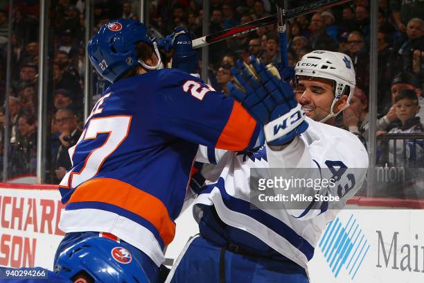Nazem Kadri of the Toronto Maple Leafs and Anders Lee of the New York Islanders get tangled up at Barclays Center on March 30, 2018 in New York City....