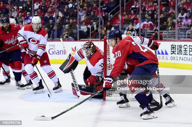 Lars Eller of the Washington Capitals brings the puck around the net in the third period against the Carolina Hurricanes at Capital One Arena on...