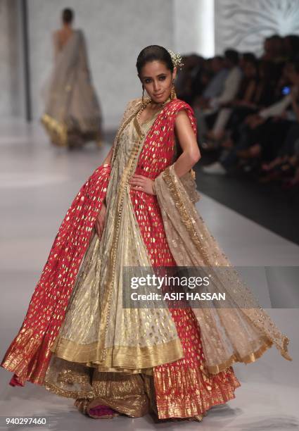 Model presents a creation by Pakistani designer Umar Sayeed on the final day of the 'Hum Showcase' Fashion Week in Karachi on late March 30, 2018. /...