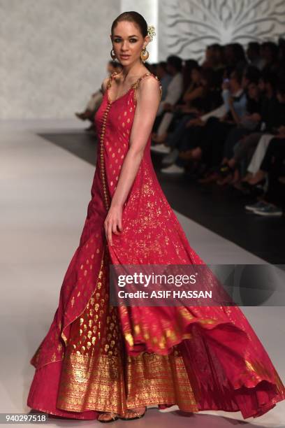 Model presents a creation by Pakistani designer Umar Sayeed on the final day of the 'Hum Showcase' Fashion Week in Karachi on late March 30, 2018. /...