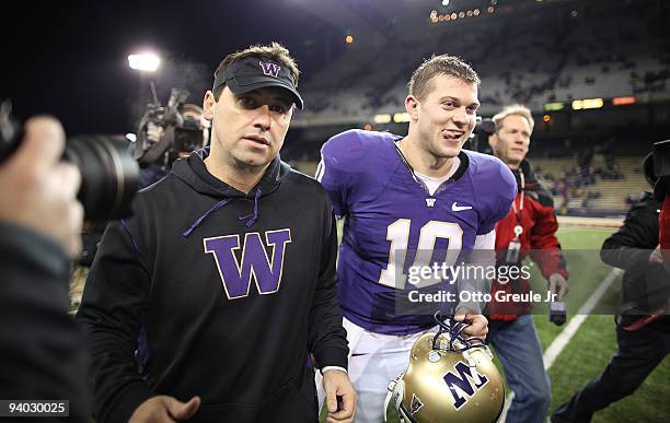 Head coach Steve Sarkisian and quarterback Jake Locker of the Washington Huskies leave the field after defeating the California Bears 42-10 on...