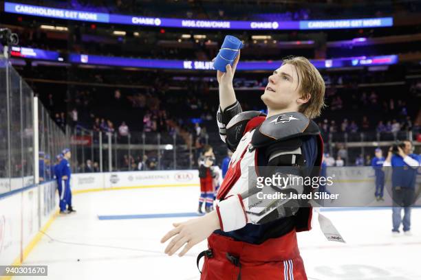 Lias Andersson of the New York Rangers throws a t-shirt to the crowd after the game against the Tampa Bay Lightning at Madison Square Garden on March...