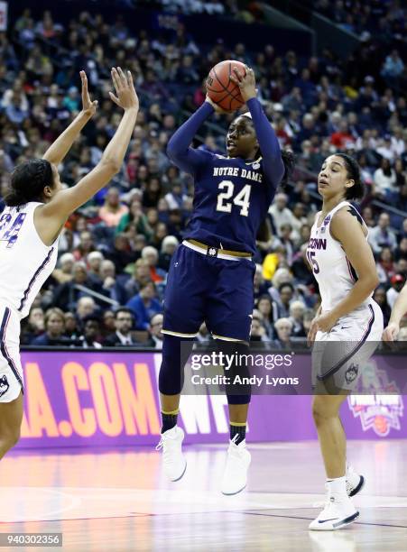 Arike Ogunbowale of the Notre Dame Fighting Irish attempts a shot defended by Gabby Williams and Napheesa Collier of the Connecticut Huskies during...