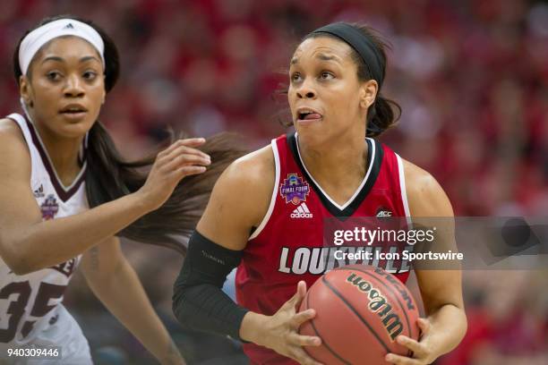 Louisville Cardinals guard Asia Durr drives past Mississippi State Lady Bulldogs guard Victoria Vivians in the division I women's championship...