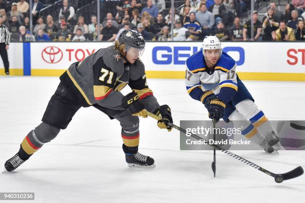 William Karlsson of the Vegas Golden Knights and Jaden Schwartz of the St. Louis Blues battle for the puck during the game at T-Mobile Arena on March...