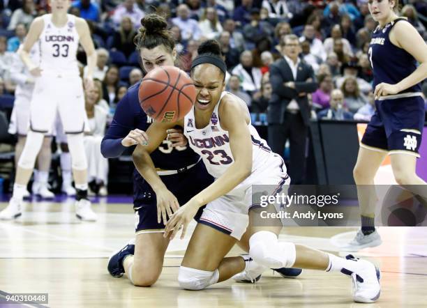 Kathryn Westbeld of the Notre Dame Fighting Irish battles for the ball with Azura Stevens of the Connecticut Huskies during the second half in the...