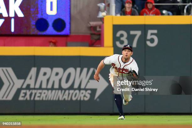 Peter Bourjos of the Atlanta Braves makes a diving catch during the ninth inning against the Philadelphia Phillies at SunTrust Park on March 30, 2018...
