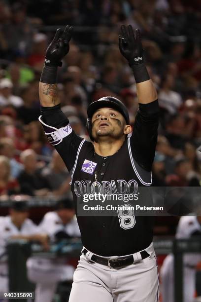 Gerardo Parra of the Colorado Rockies celebrates after hitting a two-run home run against the Arizona Diamondbacks during the fourth inning of the...