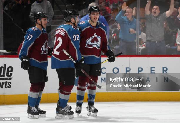 Mikko Rantanen of the Colorado Avalanche and teammates Tyson Jost and Gabriel Landeskog celebrate his goal against the Chicago Blackhawks at the...
