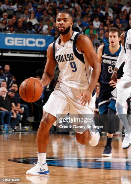 Aaron Harrison of the Dallas Mavericks handles the ball against the Minnesota Timberwolves on March 30, 2018 at the American Airlines Center in...