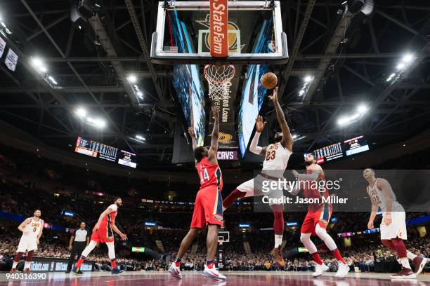 LeBron James of the Cleveland Cavaliers shoots over Solomon Hill of the New Orleans Pelicans during first half at Quicken Loans Arena on March 30,...
