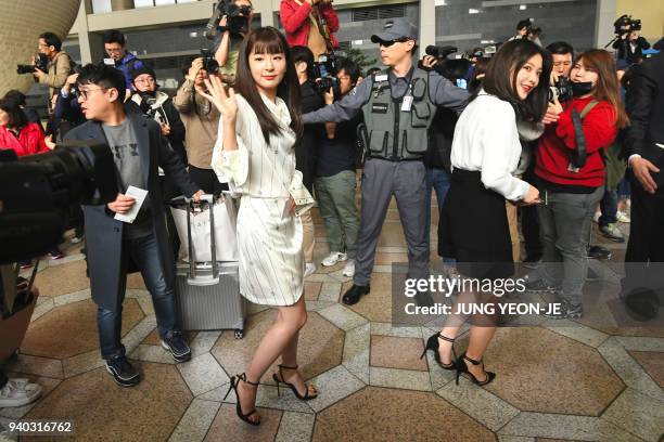 Members of K-pop girlband "Red Velvet" wave as they depart for Pyongyang from Gimpo International Airport in Seoul on March 31, 2018. K-pop stars...