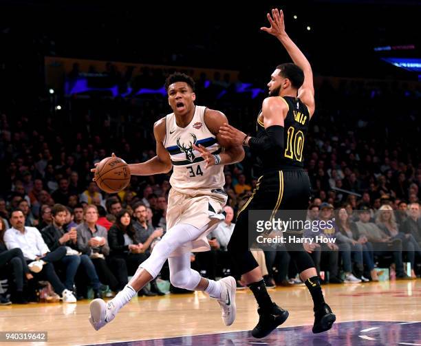Giannis Antetokounmpo of the Milwaukee Bucks drives on Tyler Ennis of the Los Angeles Lakers during the first half at Staples Center on March 30,...