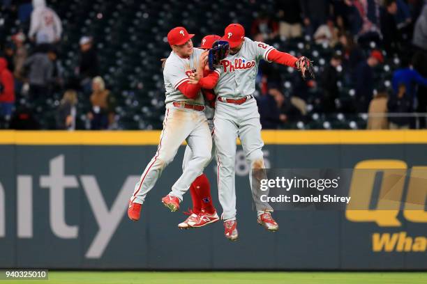 Aaron Altherr, Odubel Herrera and Rhys Hoskins of the Philadelphia Phillies celebrate beating the Atlanta Braves in eleven innings at SunTrust Park...