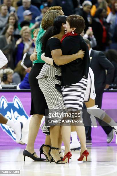 Head coach Muffet McGraw of the Notre Dame Fighting Irish celebrates with her staff after her team defeated the Connecticut Huskies in overtime in...