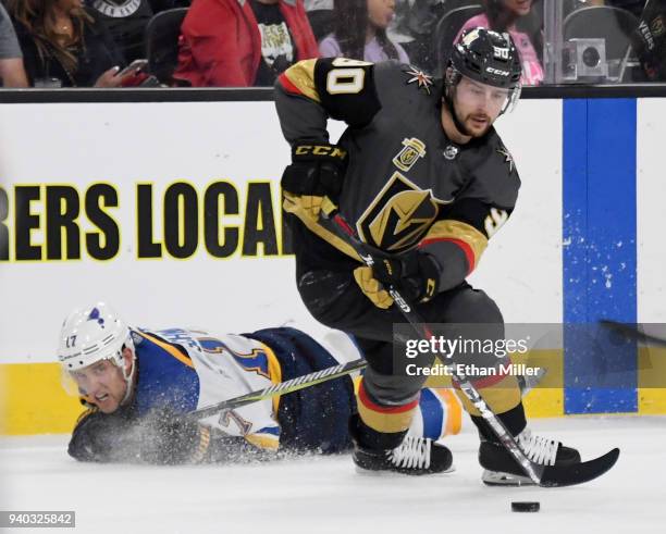 Tomas Tatar of the Vegas Golden Knights skates with the puck against Jaden Schwartz of the St. Louis Blues in the second period of their game at...