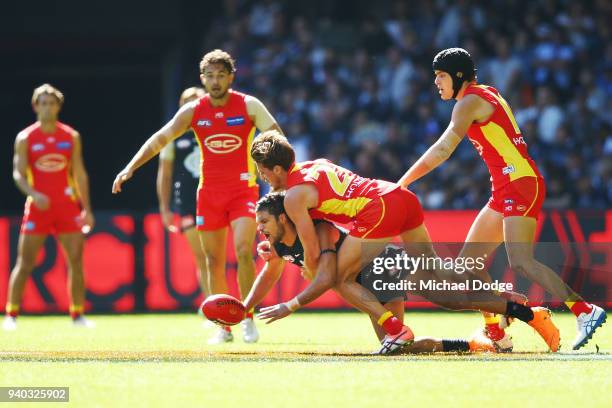 David Swallow of the Suns tackles Jarrod Harbrow of the Suns during the round two AFL match between the Carlton Blues and the Gold Coast Suns at...