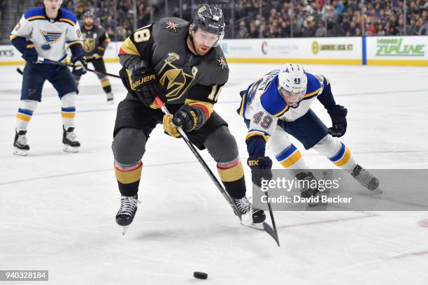 James Neal of the Vegas Golden Knights and Ivan Barbashev of the St. Louis Blues skate to the puck during the game at T-Mobile Arena on March 30,...