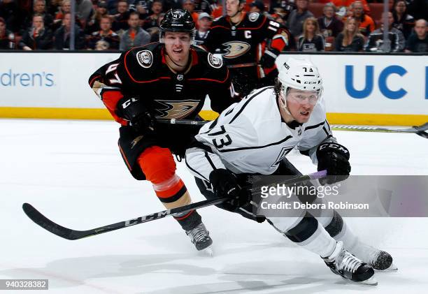 Tyler Toffoli of the Los Angeles Kings and Hampus Lindholm of the Anaheim Ducks skate during the game on March 30, 2018 at Honda Center in Anaheim,...
