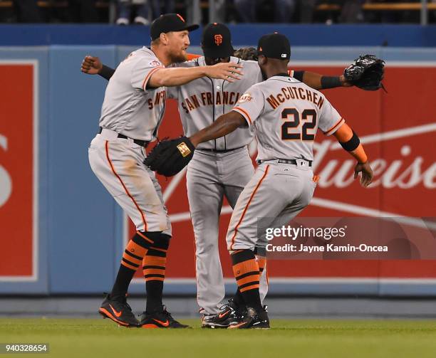 Hunter Pence, Austin Jackson and Andrew McCutchen of the San Francisco Giants celebrate in the outfield after defeating the Los Angeles Dodgers at...