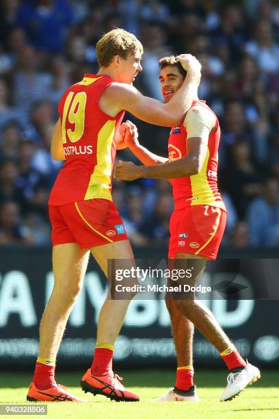 Tom Lynch of the Suns and Jack Martin celebrate a goal during the round two AFL match between the Carlton Blues and the Gold Coast Suns at Etihad...